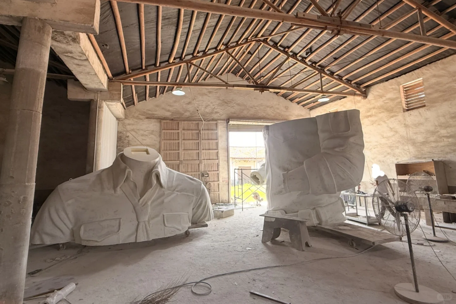 Semi-finished components of the custom giant FRP sculpture waiting for assembly and surface treatment in the workshop.