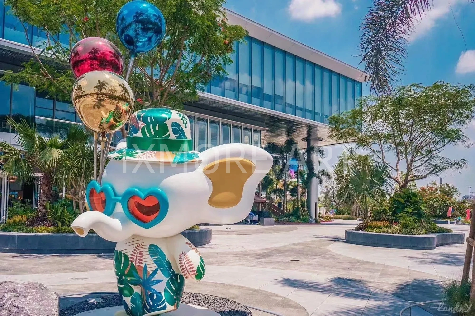 Long shot of Tropical Baby Elephant IP sculpture outside mall, mist spray dynamic device customized by professional art factory, overall finished effect of large outdoor public art installation(5)