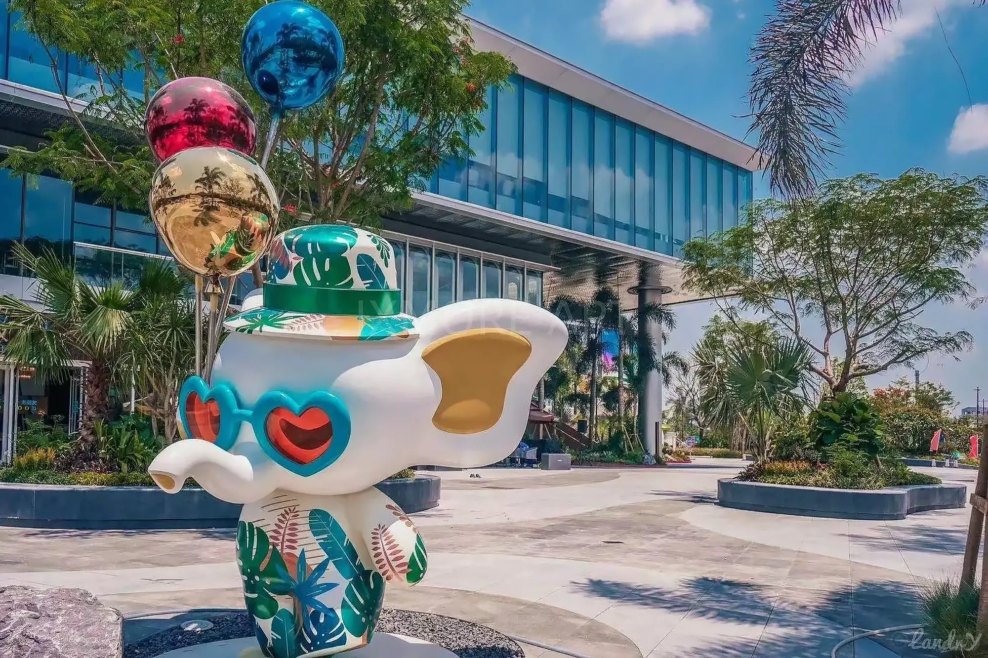Long shot of Tropical Baby Elephant IP sculpture outside mall, mist spray dynamic device customized by professional art factory, overall finished effect of large outdoor public art installation(5)